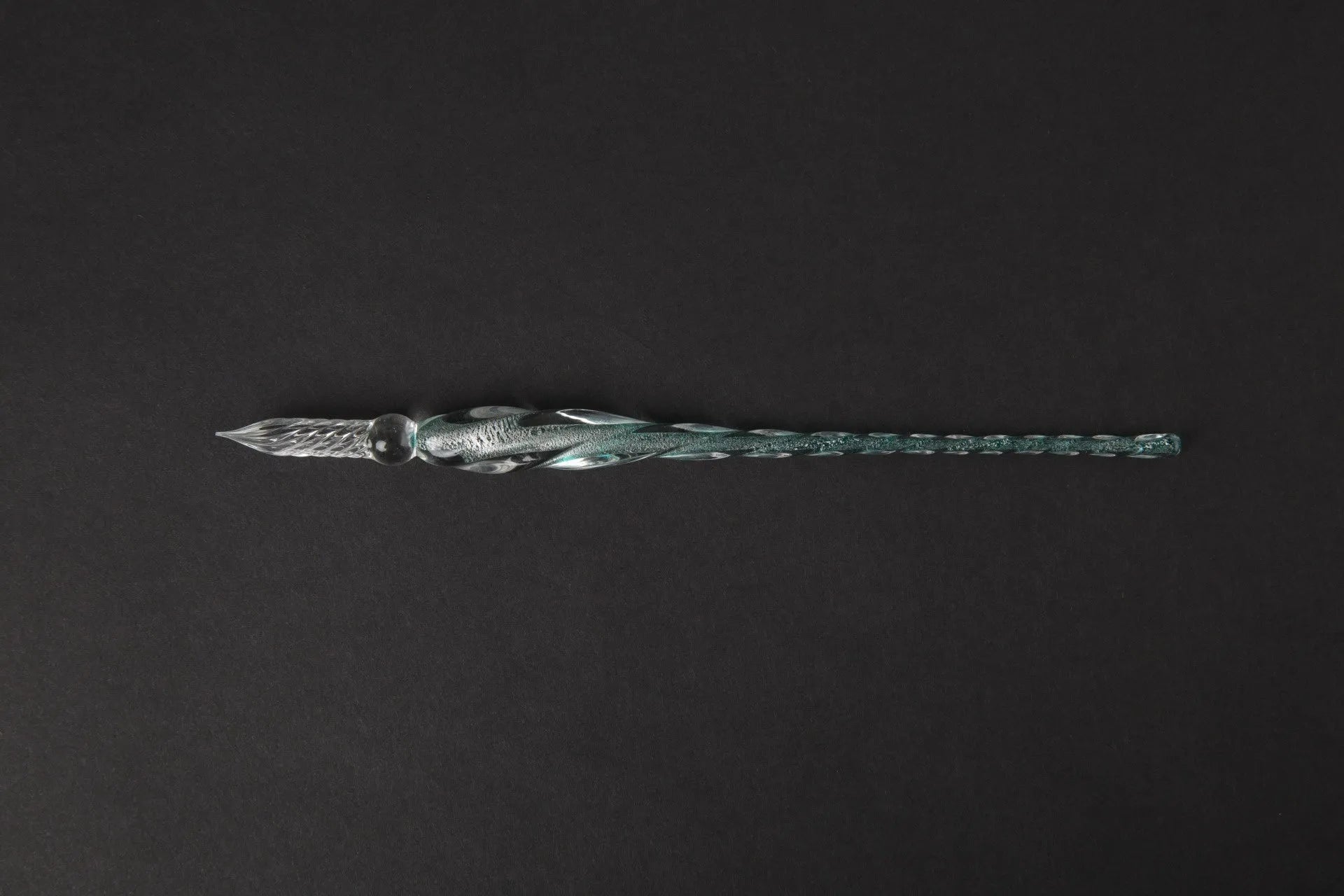 Transparent glass crystal pen with coloured ink visible inside, abstract modelling design