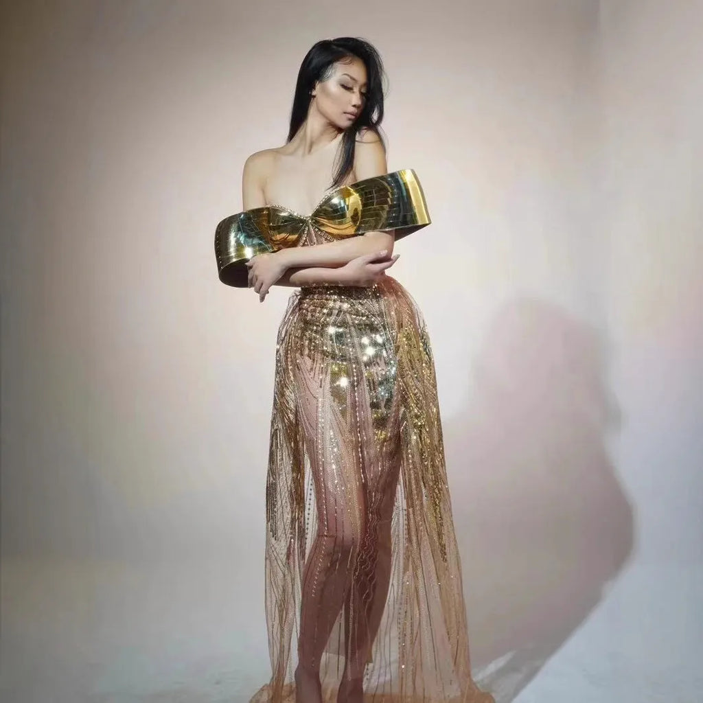 Gold sequinned strapless long evening dress with a high thigh split on a model.