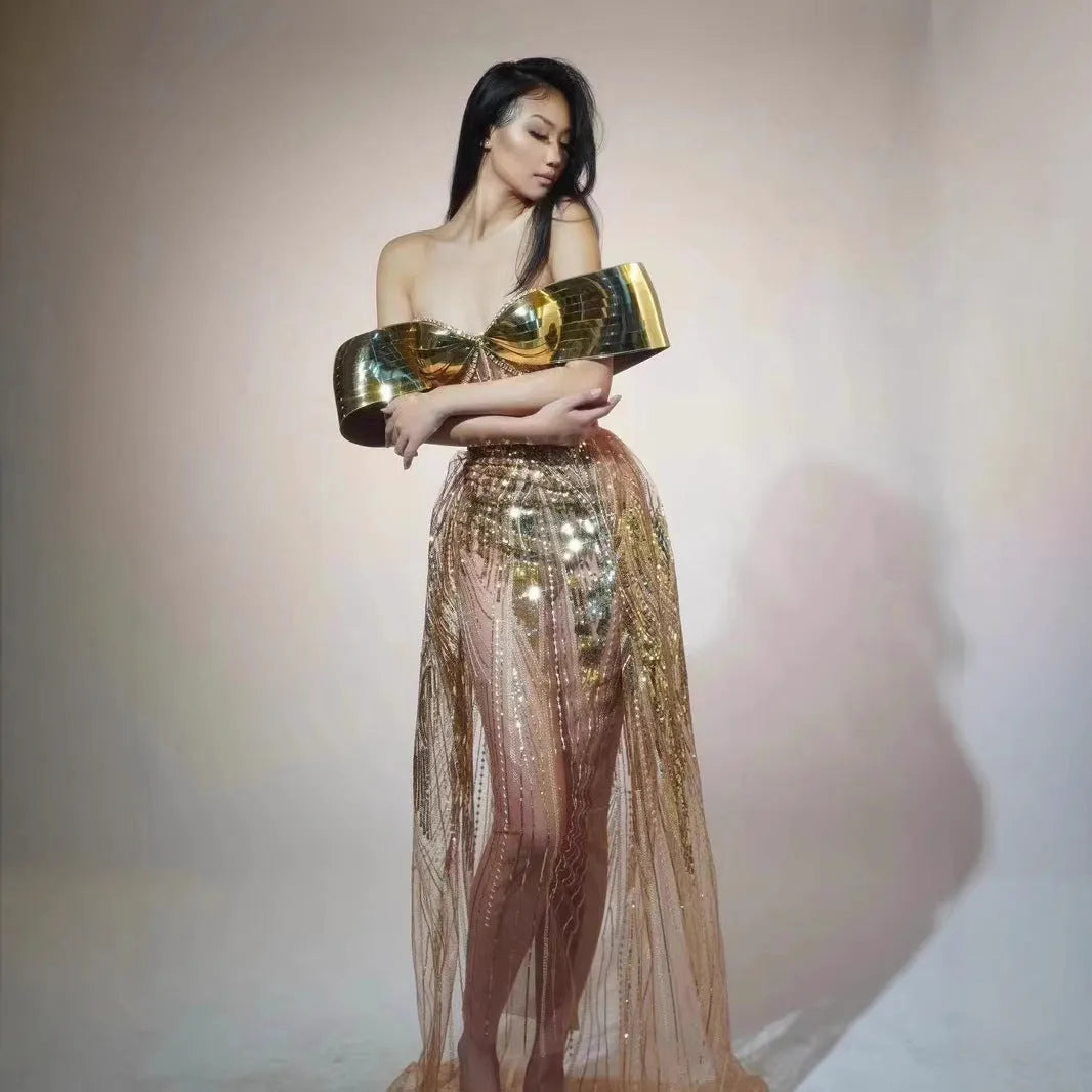 Gold sequinned strapless long evening dress with a high thigh split on a model.