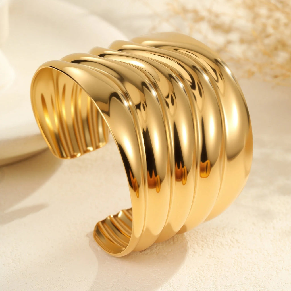 Women's stainless steel bracelet with geometric wave design and gold plating