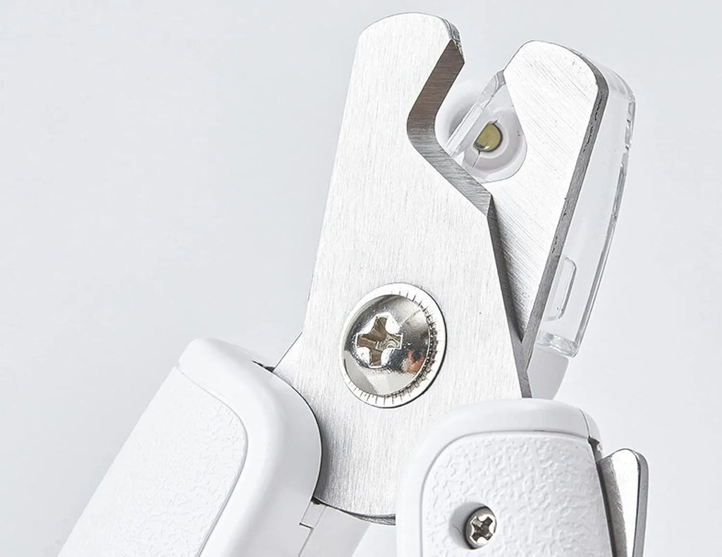 White LED pet nail clipper with a transparent anti-splash guard and a nail file on a white background.