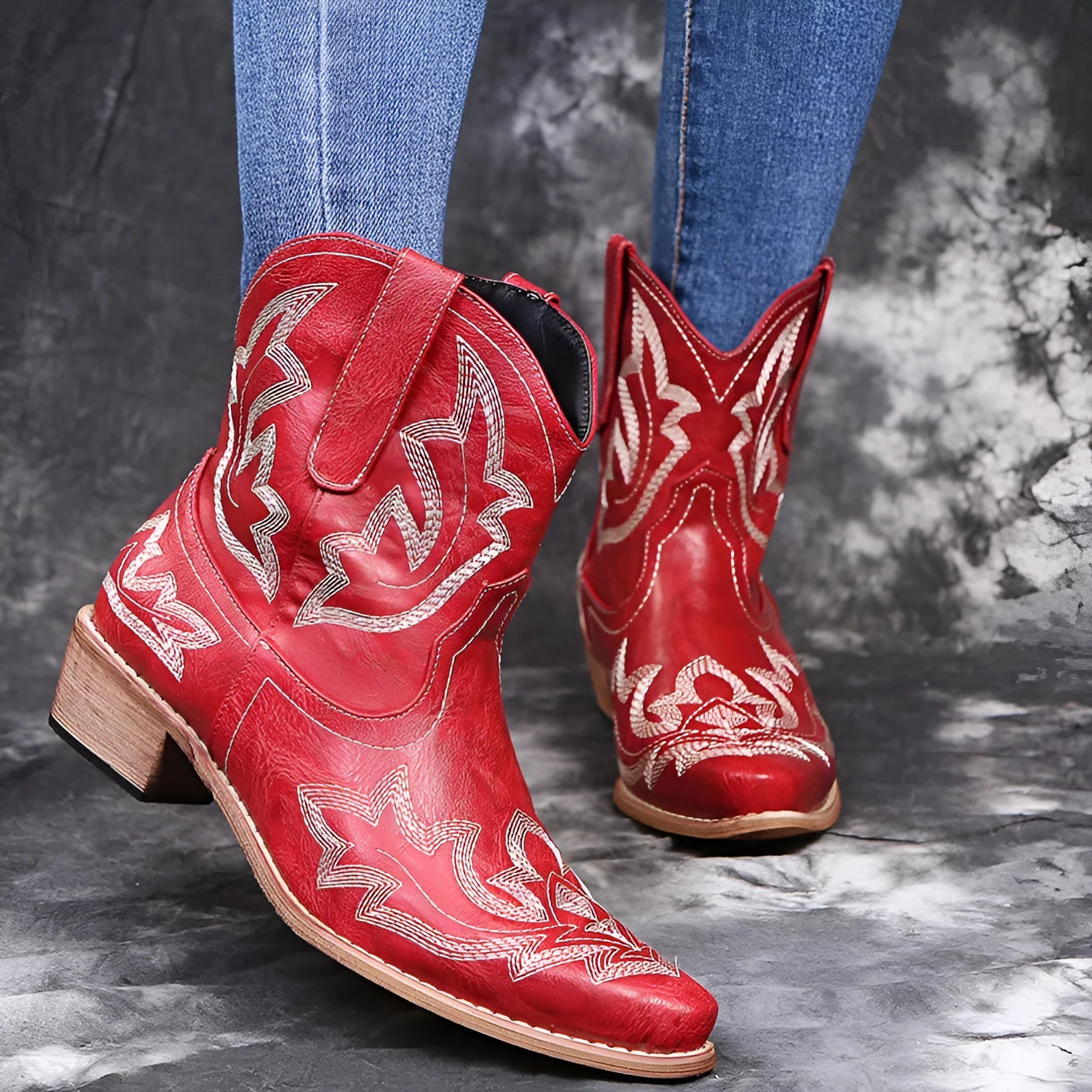 Women's blue embroidered cowboy boots with low chunky heel and pointed toe.