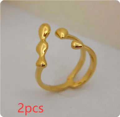 Brass adjustable fashion ring with spherical detail in gold or silver finish.