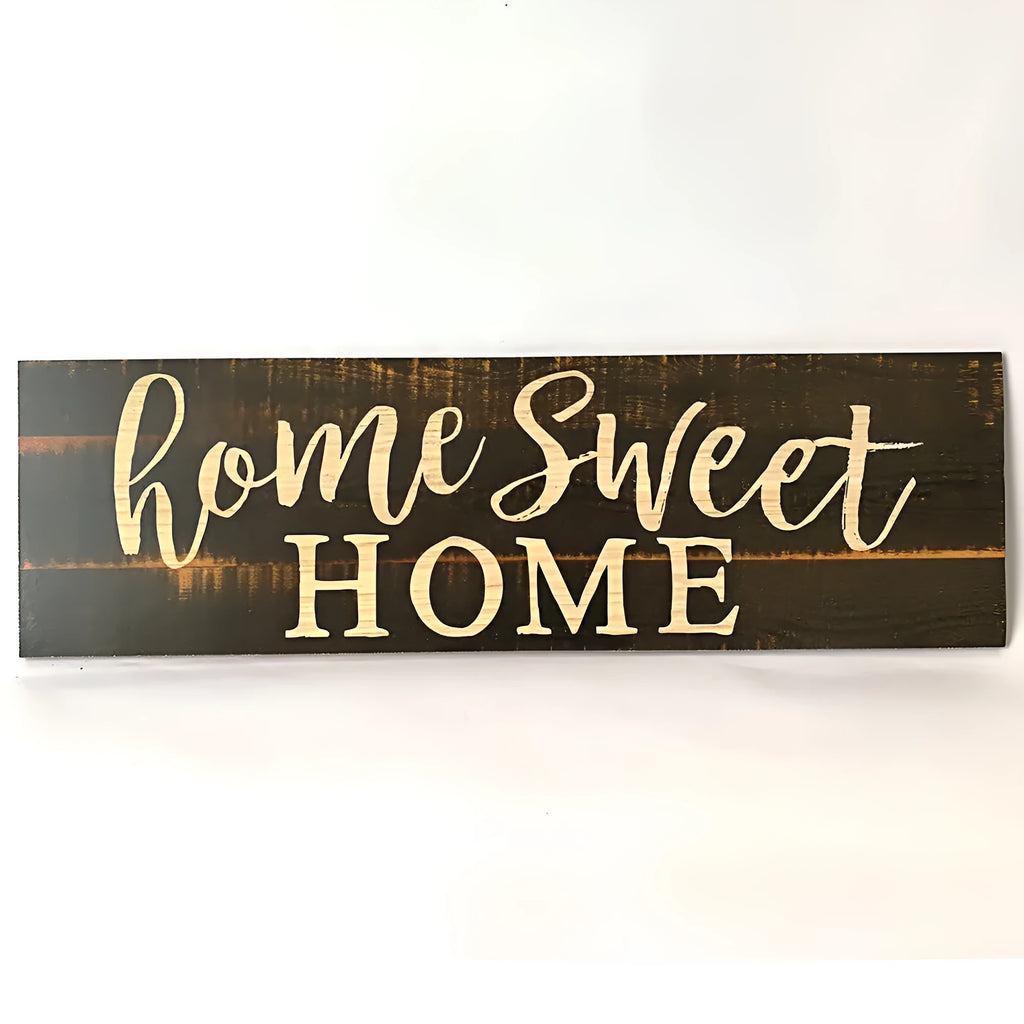 Black wooden wall plaque with carved white HOME SWEET HOME text, showing its rectangular shape.