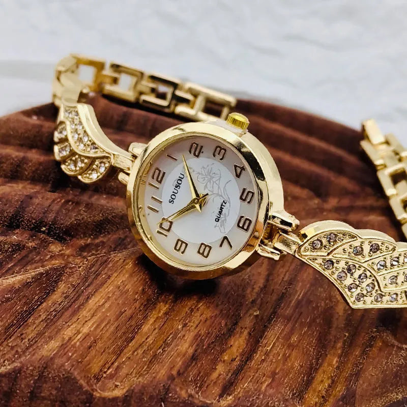 Stainless steel women's watch with round dial on wrist showing gold surface colour
