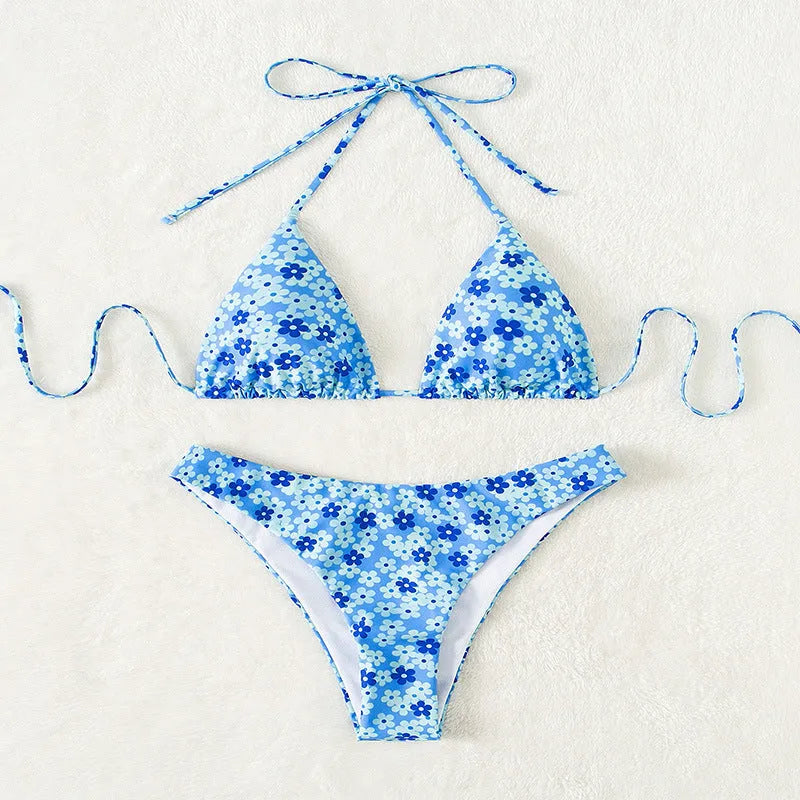 Women's blue printed two-piece swimsuit with lace-up front on ruffled shorts and sleeveless top.