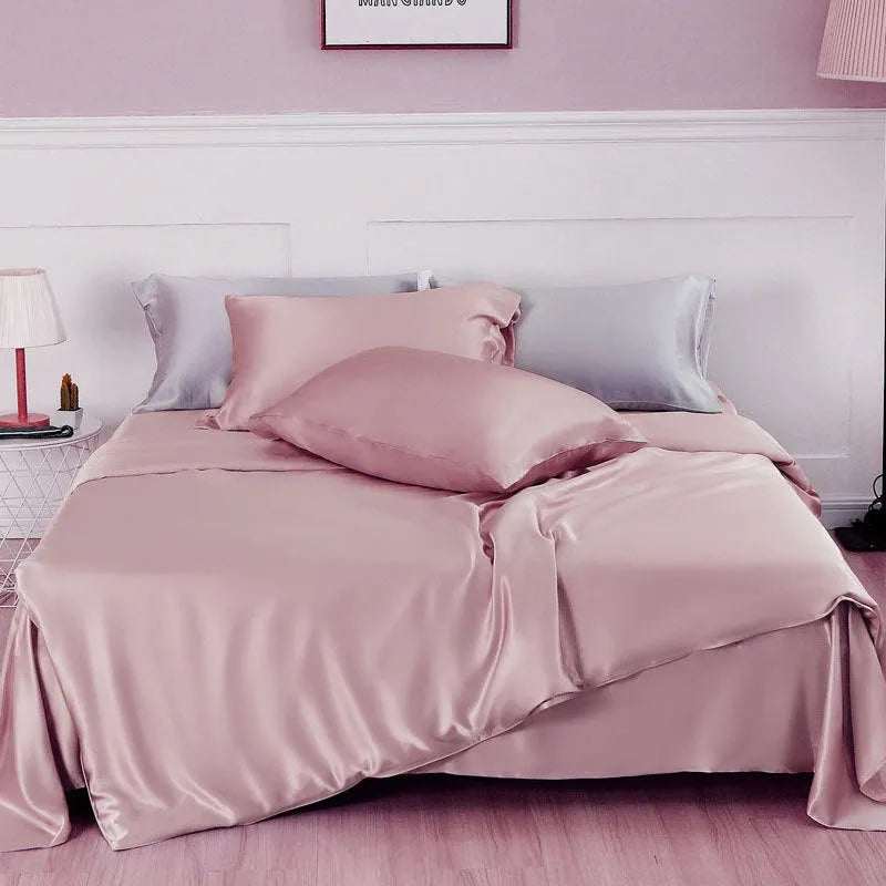 Double-sided solid colour silk duvet cover shown in Lotus Pink on a bed
