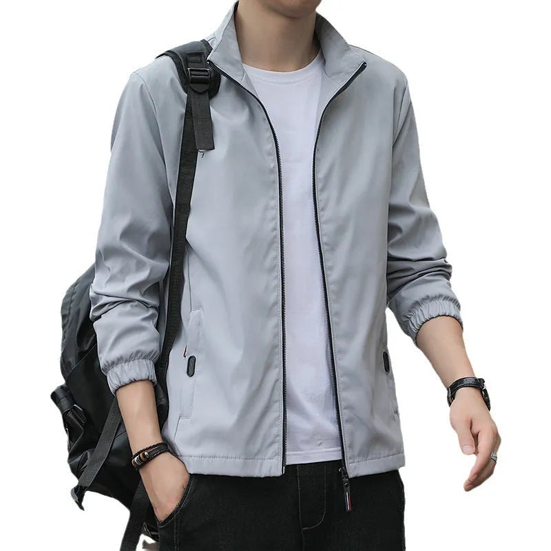 Man wearing a black Korean-style loose lapel casual jacket with zipper pockets