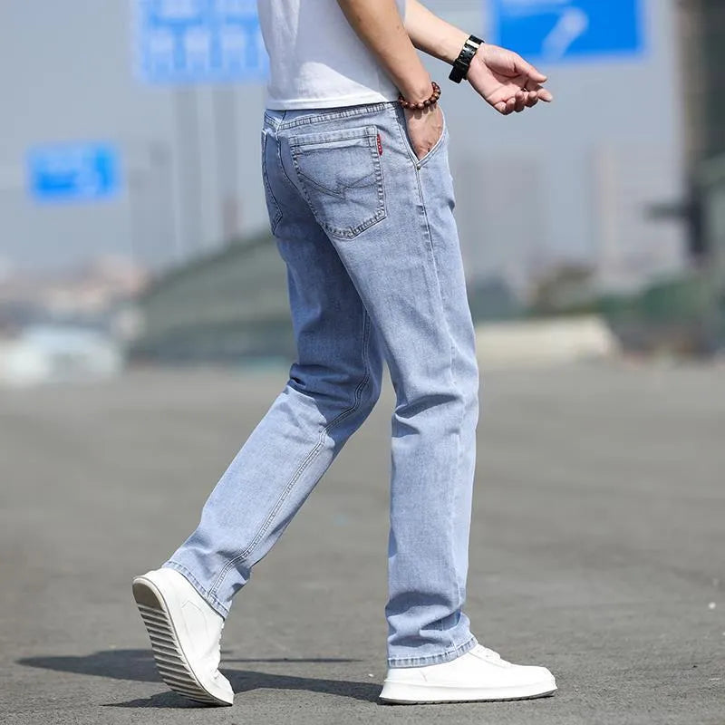Men's smoky gray straight leg jeans with low waist and zipper fly closure