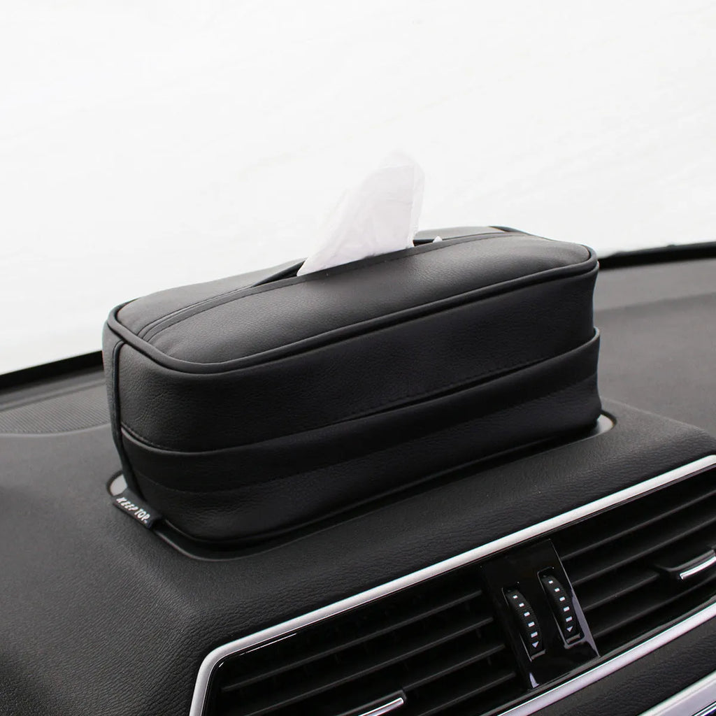 Black PU leather hanging storage box for car console organisation, shown with paper bag filler.
