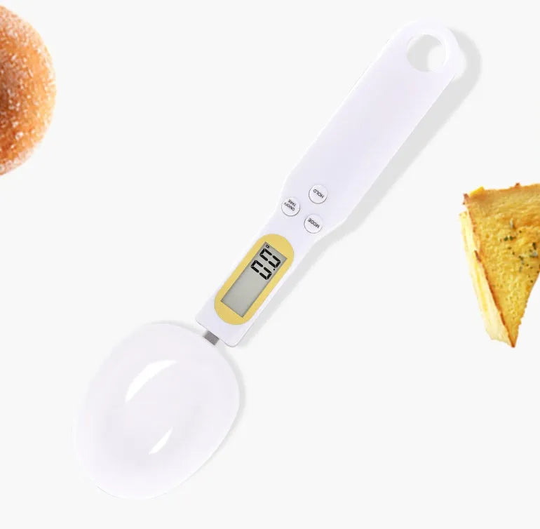 Black electronic digital measuring spoon scale on a kitchen worktop showing weight display.