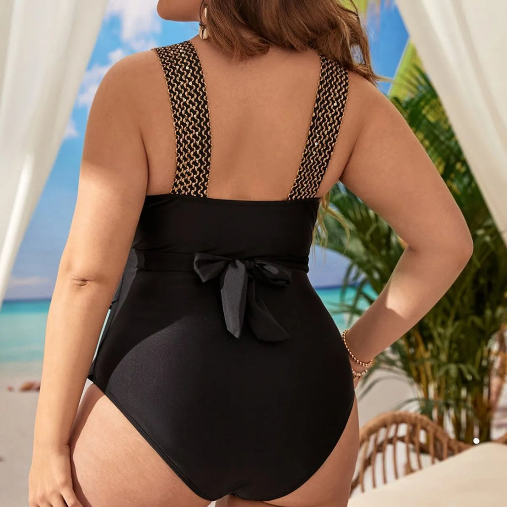 Women's black one-piece swimsuit with sleeveless design and built-in chest pad on a mannequin.