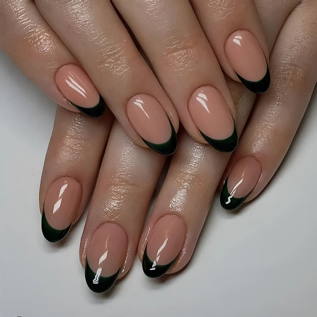 Set of 24 short almond coffin shaped press-on nails with black French tips on a white base.