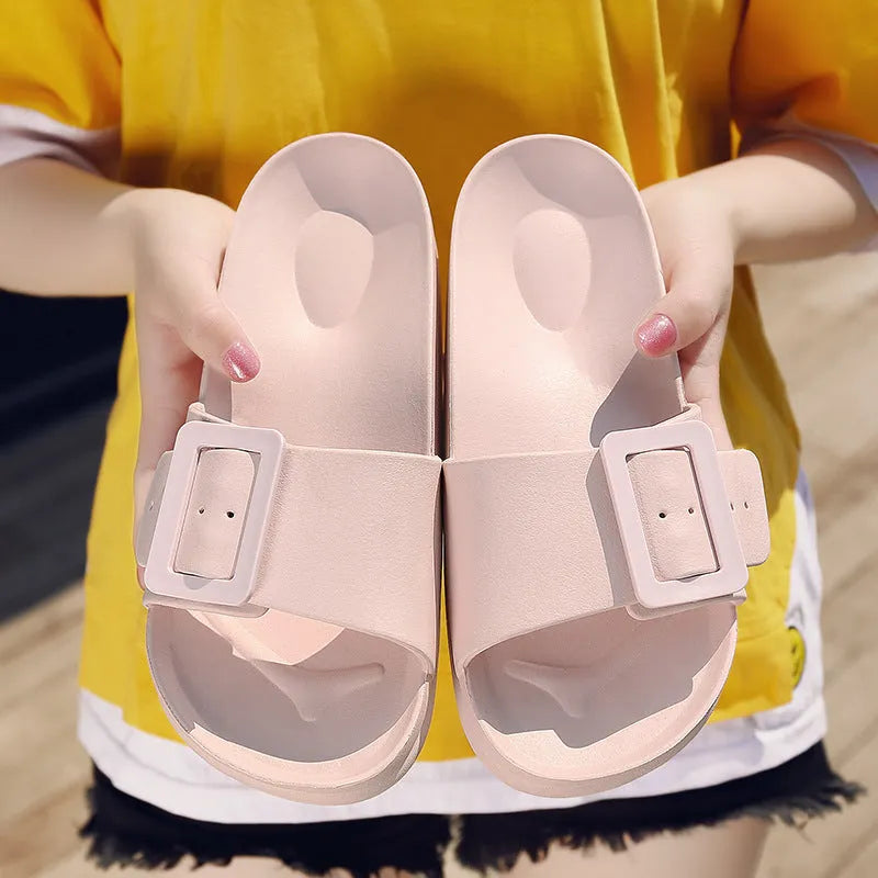 Women's grey blue buckle flip flop sandals with EVA sole on neutral background