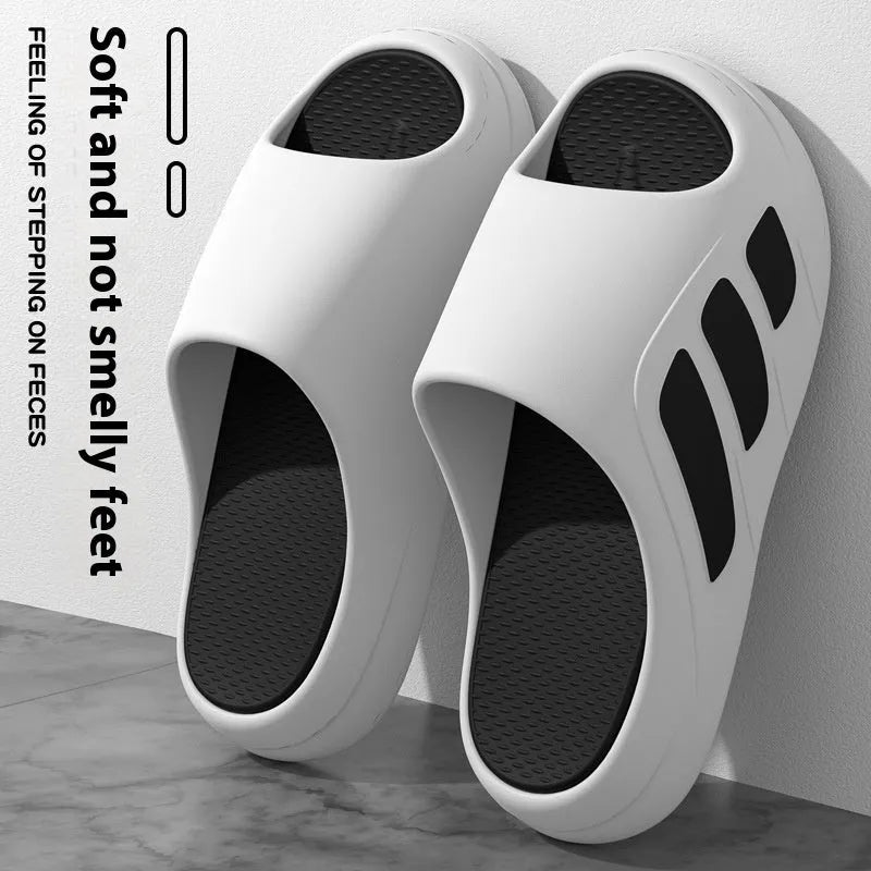 Pair of EVA platform slippers in a two-tone colour scheme, showing flip-flop style with letter detailing.