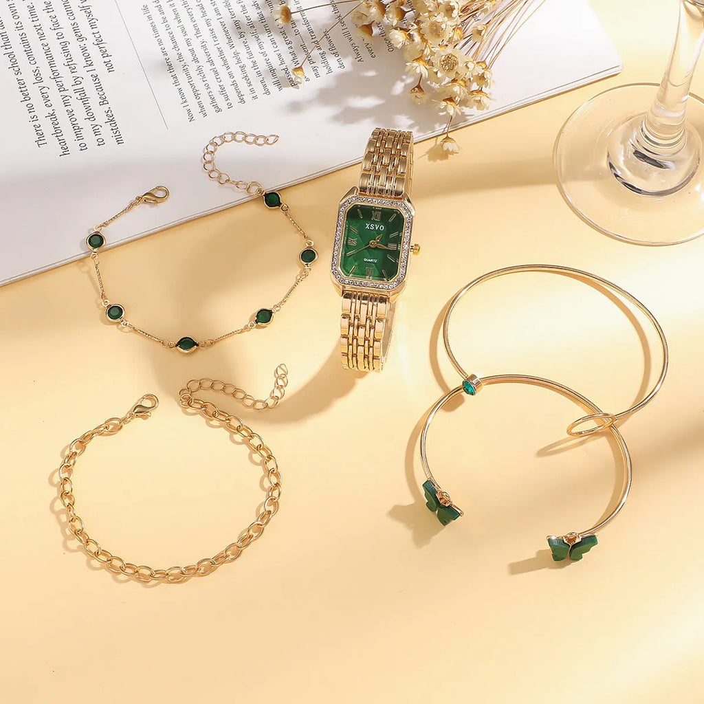 Gold green square women's watch with four matching bracelets on display