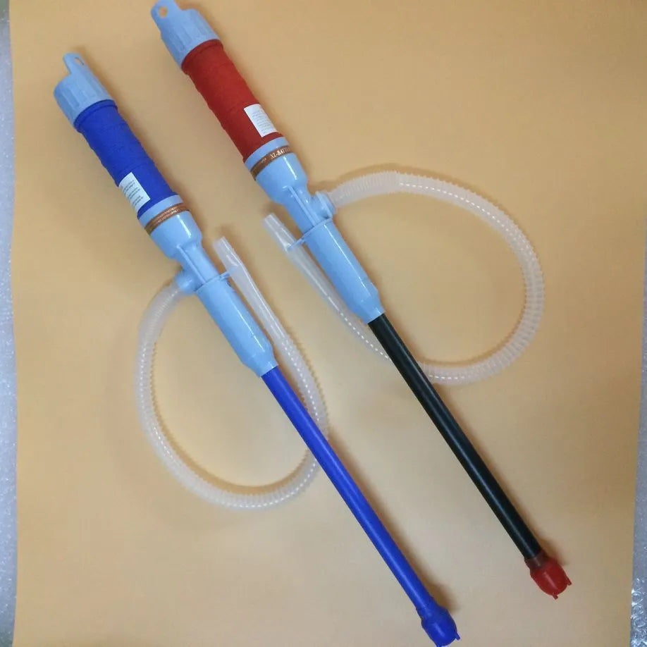 Red and blue manual hand pump siphon for transferring fuel oil and gasoline