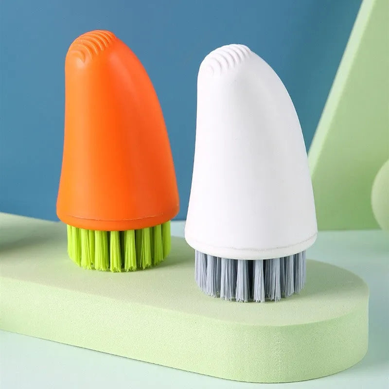 Carrot-shaped orange and white kitchen cleaning brush with nylon bristles