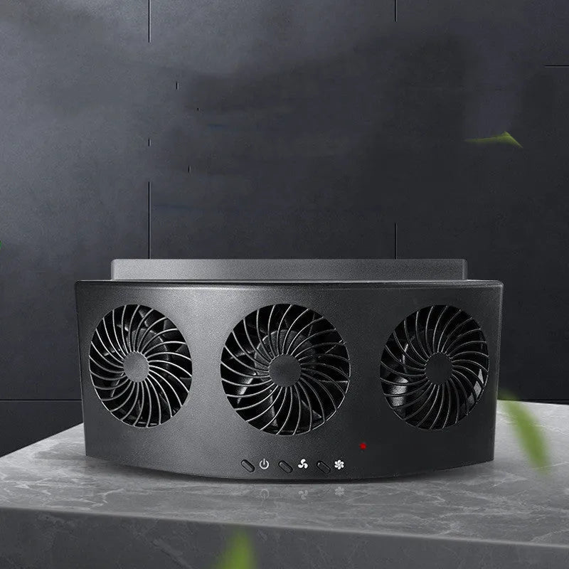 Black and white USB-powered car ventilation fan for exhaust odour removal on windowsill.