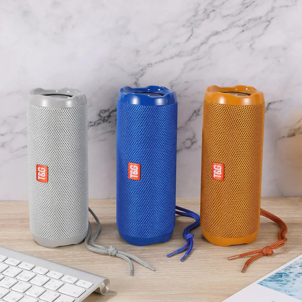 Fabric portable Bluetooth speaker with integrated card holder shown in multiple colour options.