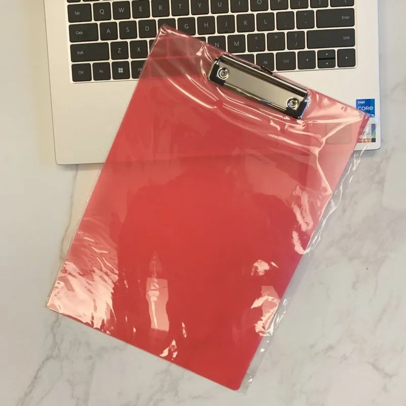 A4 transparent plate holder with metal clip holding documents in office setting