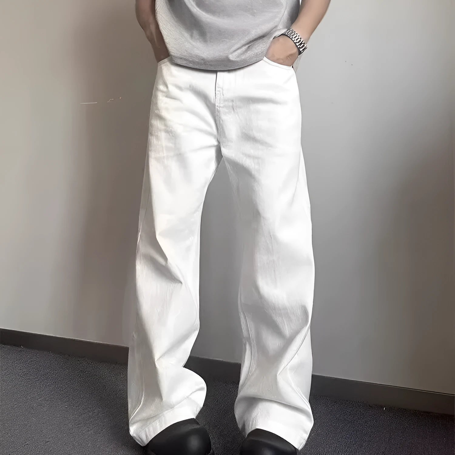 White men's straight-leg jeans with a wide loose cut on a mid waist, featuring a zipper fly.