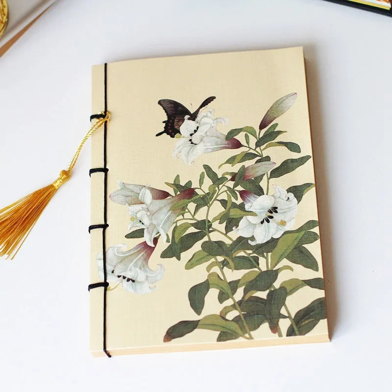 A5 antique wire-bound notebook with retro painting cover, thread binding, and black tassels.