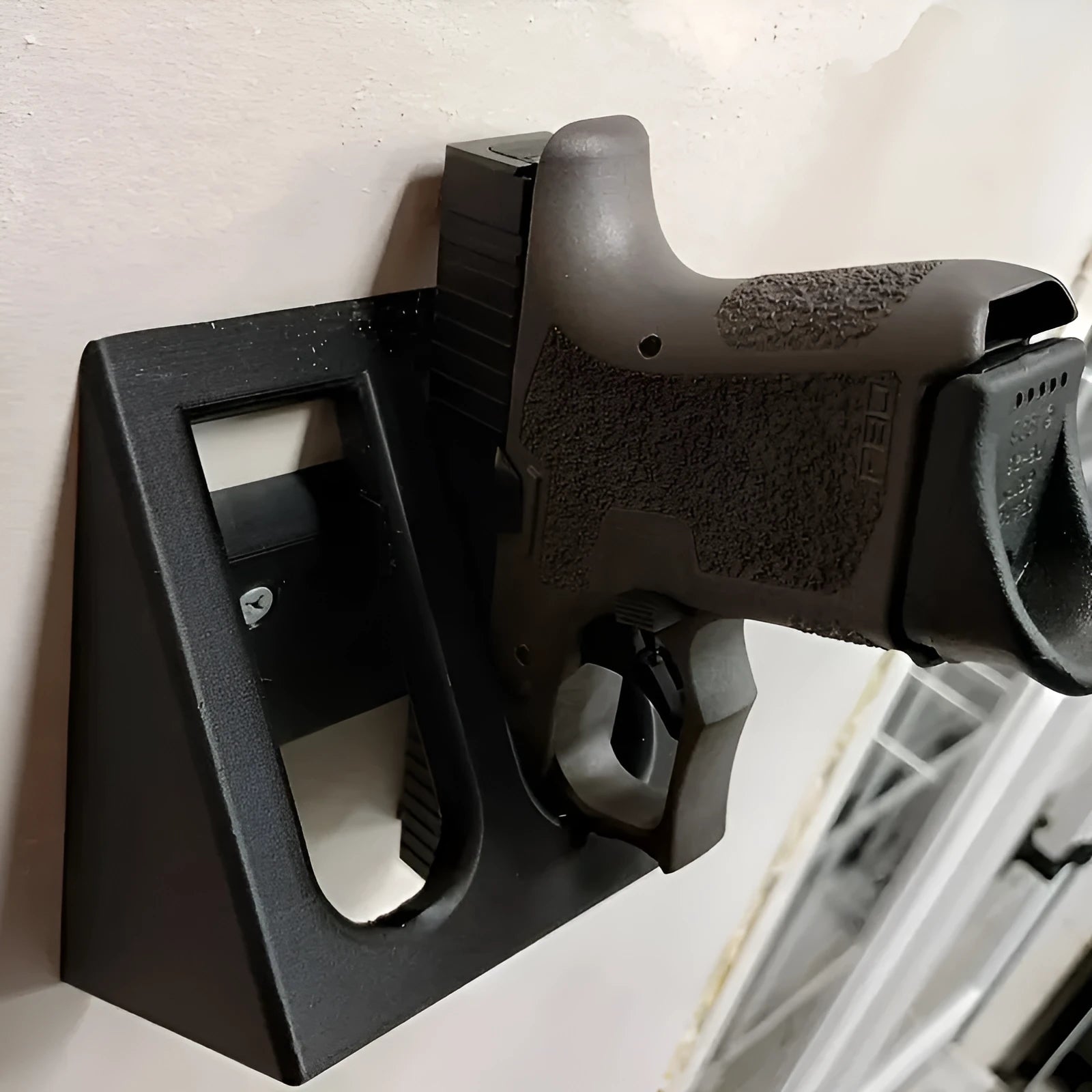 Black punk-style plastic pistol display stand for collectible airsoft pistols and models.