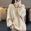 Women's camel coloured V-neck long sleeve viscose pullover sweater laid flat.