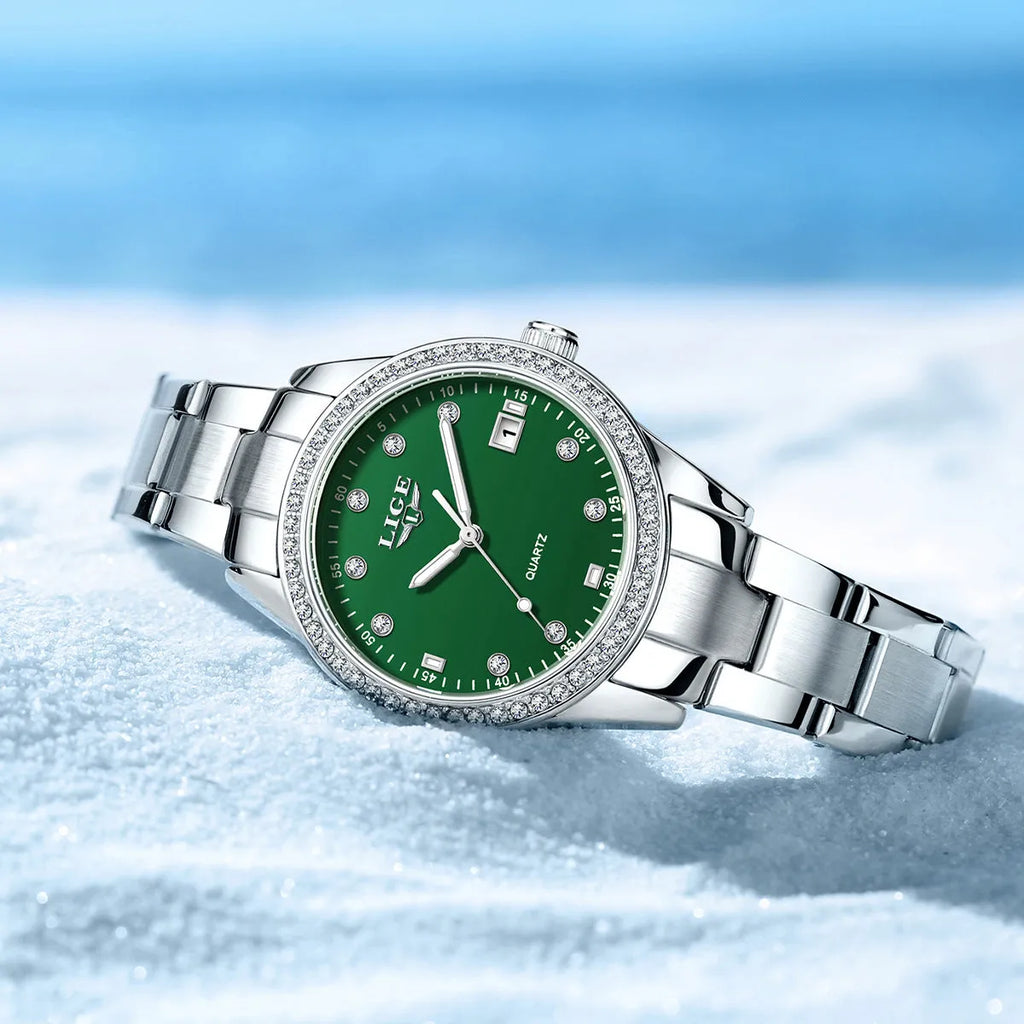Women's silver fashion quartz watch with diamond bezel, luminous hands on a coloured dial, showing side profile with spiral crown.