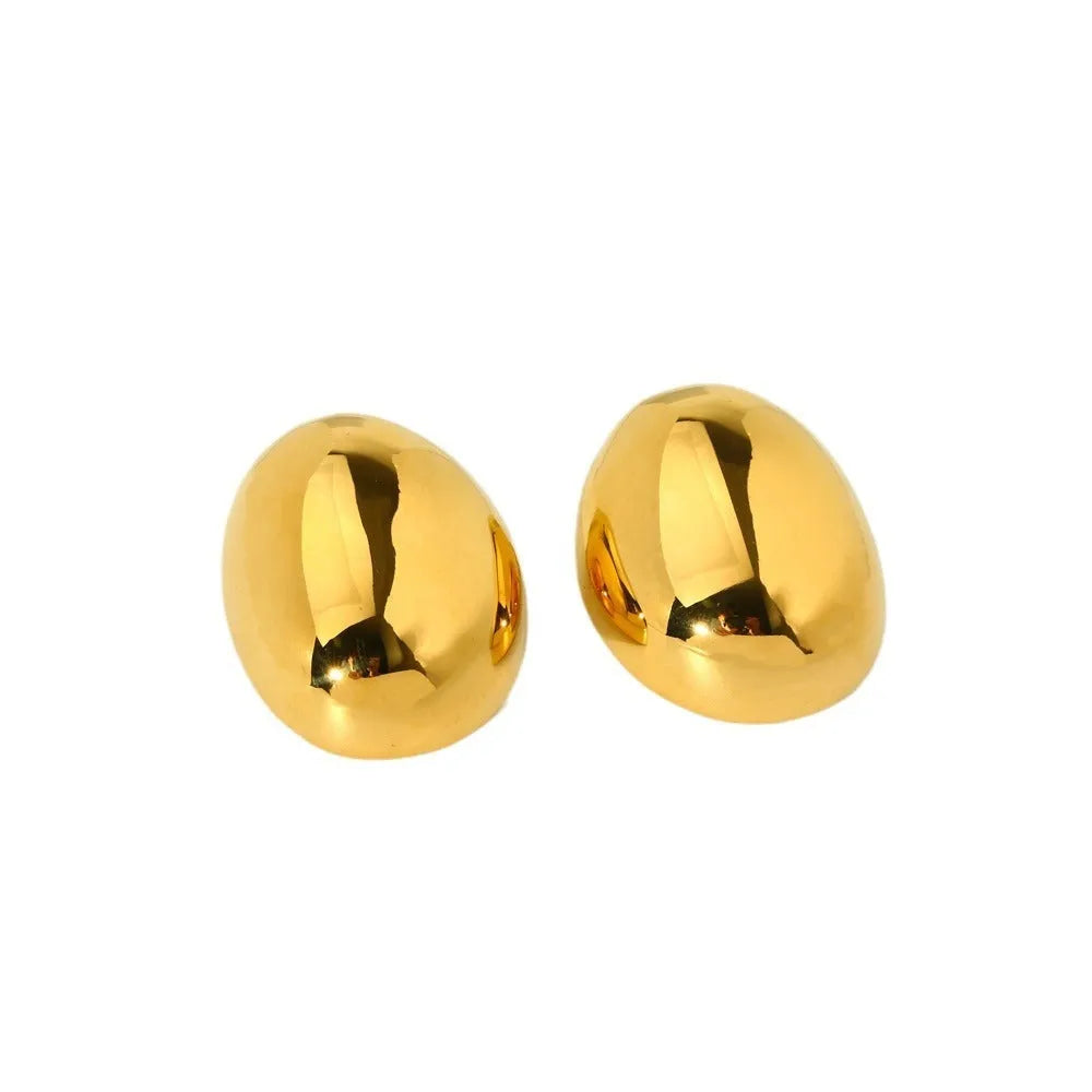 A pair of geometric stainless steel ear studs with a linear design and a glazed gold-coloured surface.