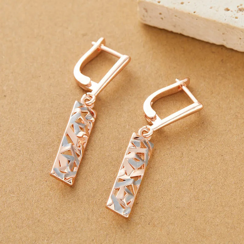 A pair of rectangular hollow stud earrings with a two-tone electroplated finish on a white background.