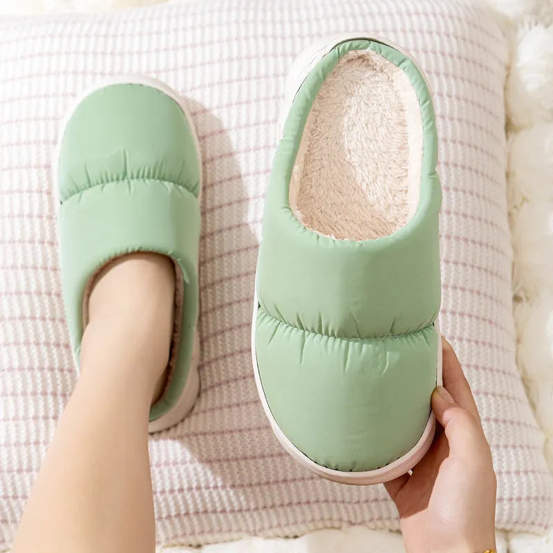 A pair of down cotton slippers with an artificial leather upper and thick rubber sole, shown in blue.