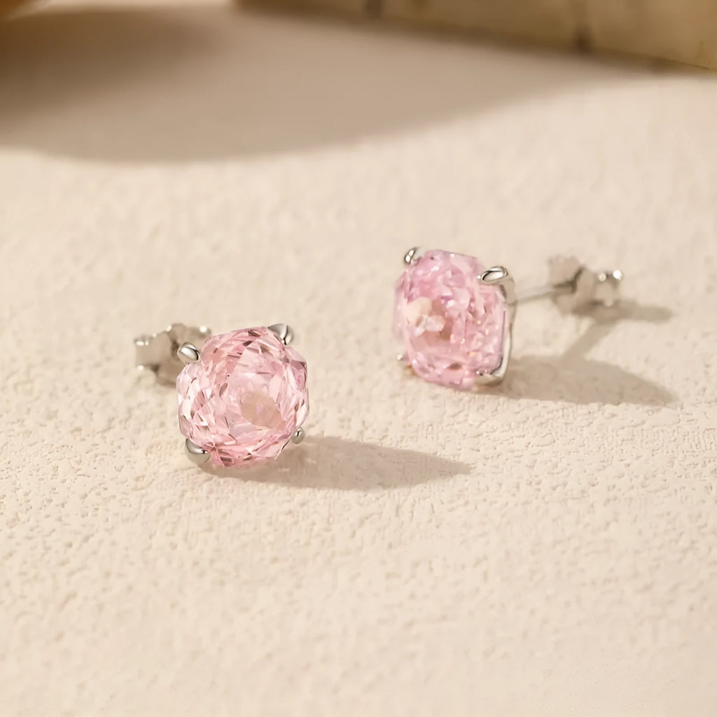 Close-up of a pair of pink rose stud earrings made from S925 sterling silver, shown on a plain background.