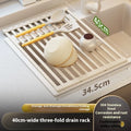 Milky white foldable stainless steel kitchen draining rack shown in a sink.
