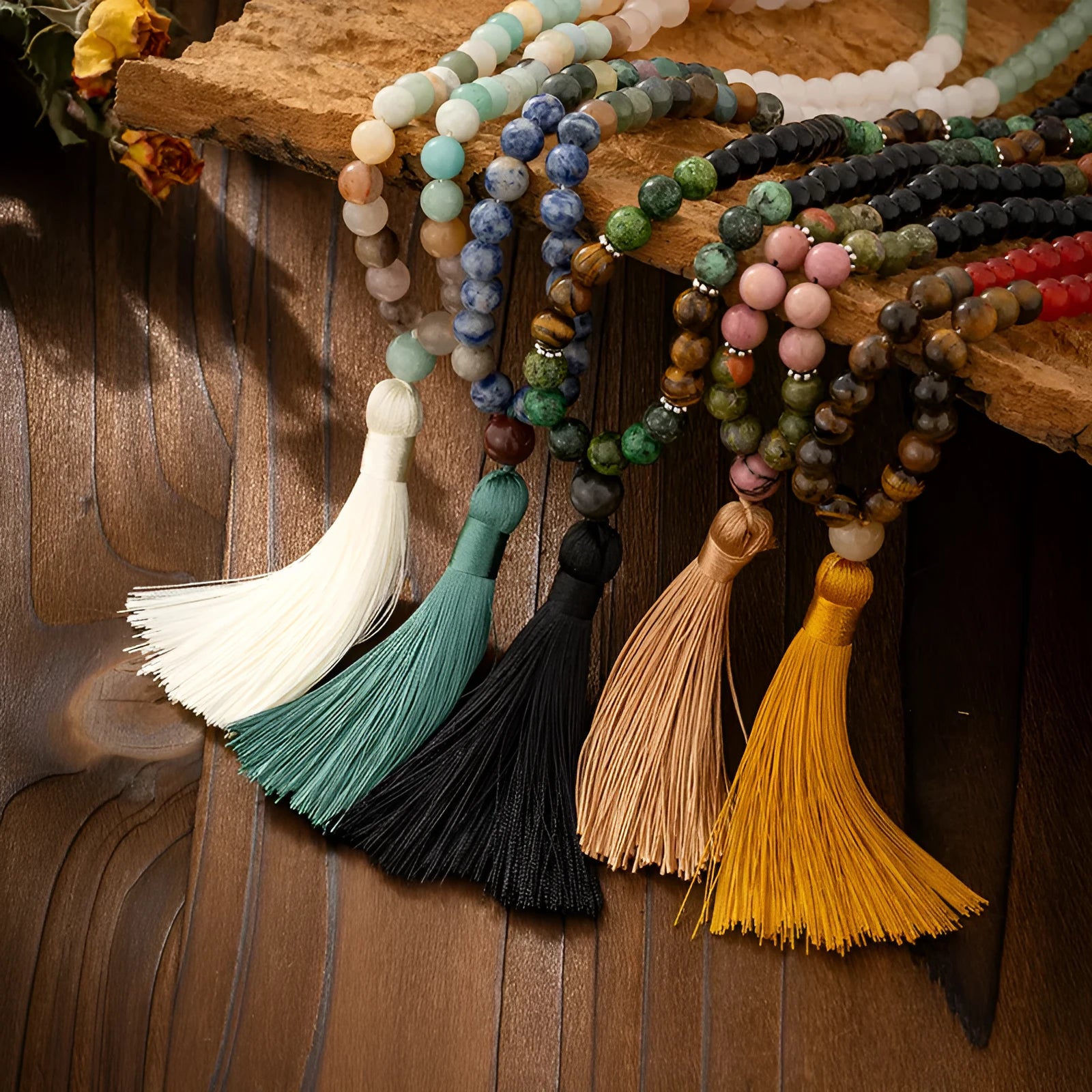 Bohemian-style long necklace chain with vintage tassel and matching bracelet on dark background