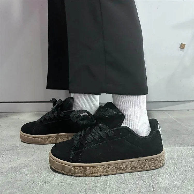 Black retro low-top sneakers with round toe design and waterproof platform construction