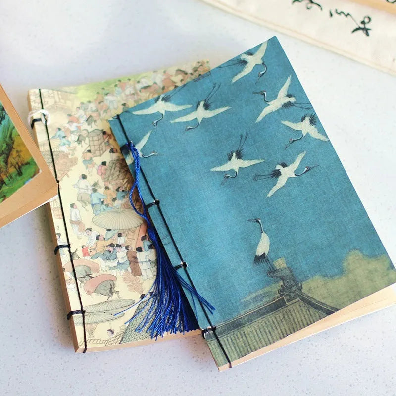 A5 antique wire-bound notebook with retro painting cover, thread binding, and black tassels.