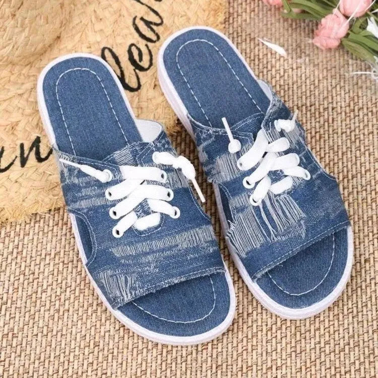Blue Roman style canvas slippers with cloth upper and rubber sole displayed in adult sizes