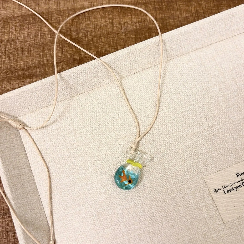 Women's joker design pendant necklace with coloured glaze charm on a cotton and linen clavicle chain.