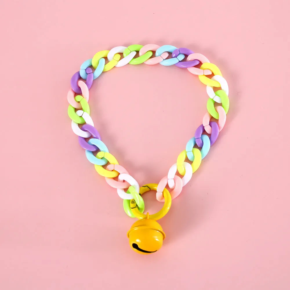 Adjustable plastic pet collar in macaron candy colours on a white background.