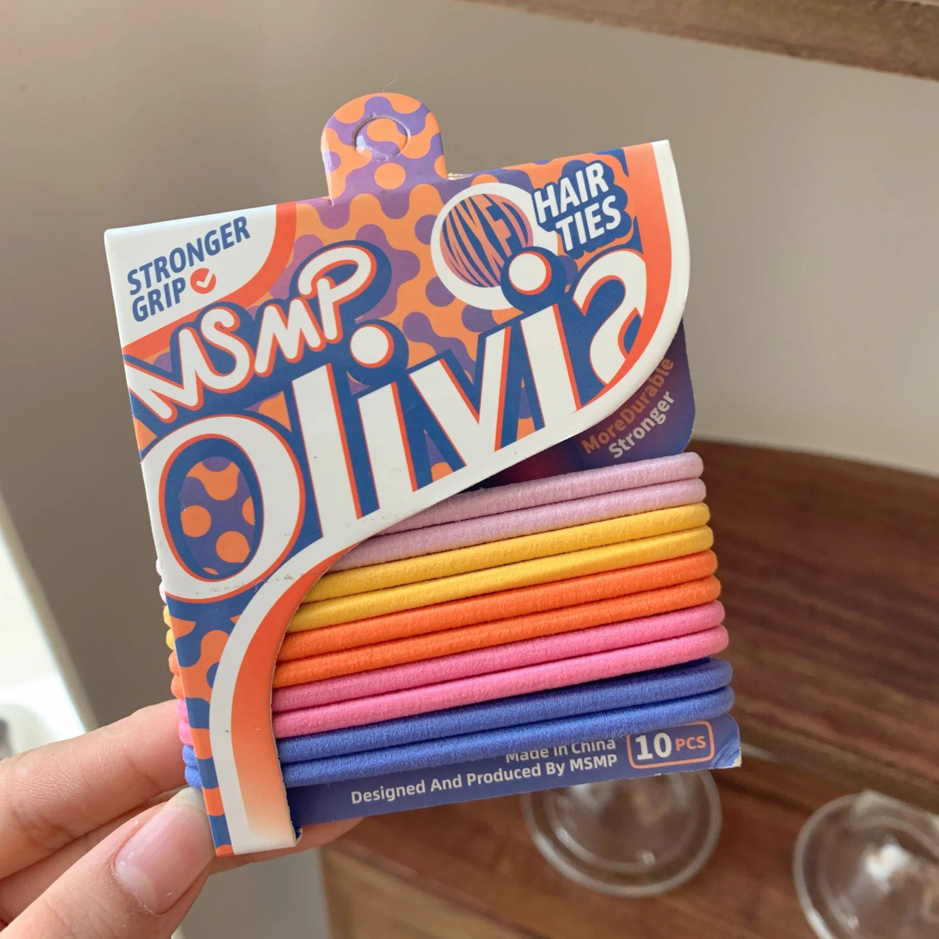Assortment of candy coloured braided elastic hair bands on a white background.