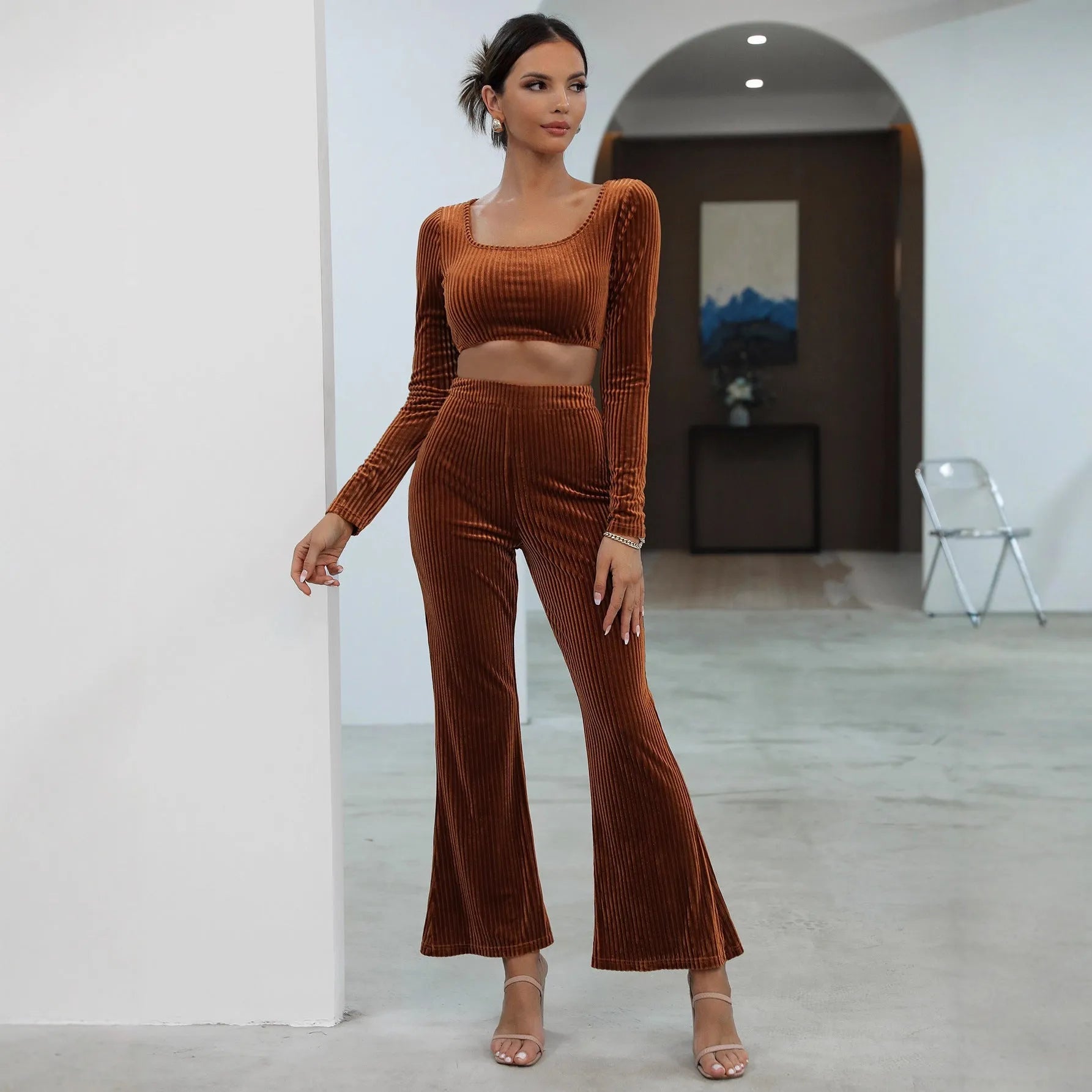 Caramel coloured women's long sleeve sweater set with matching trousers on a hanger.