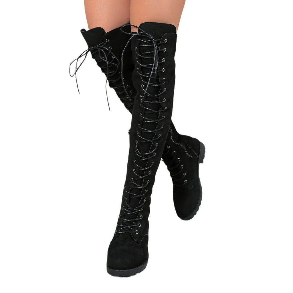 Women's black lace-up over-the-knee boots with a flat rubber sole and visible stitching detail.