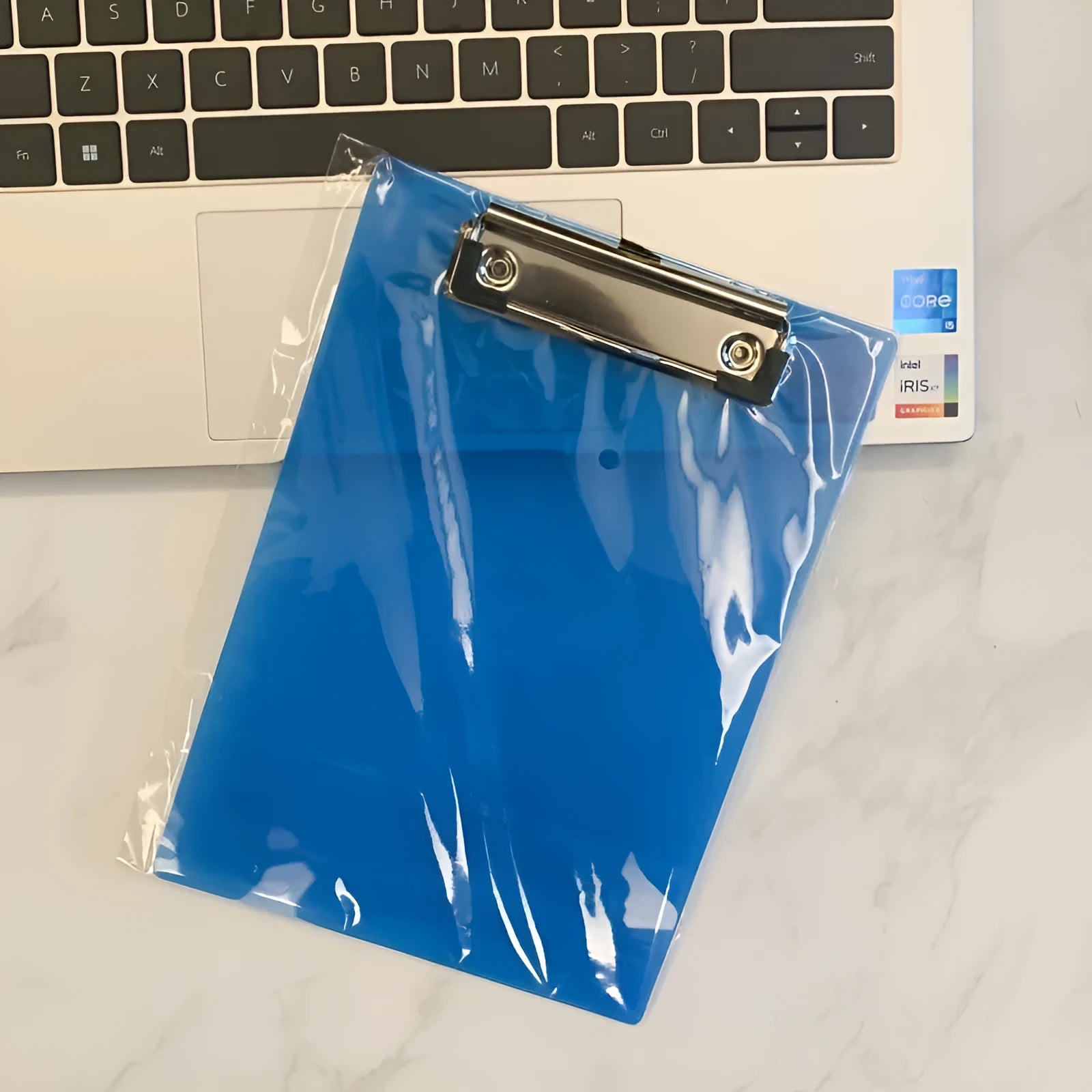 A4 transparent plate holder with metal clip holding documents in office setting