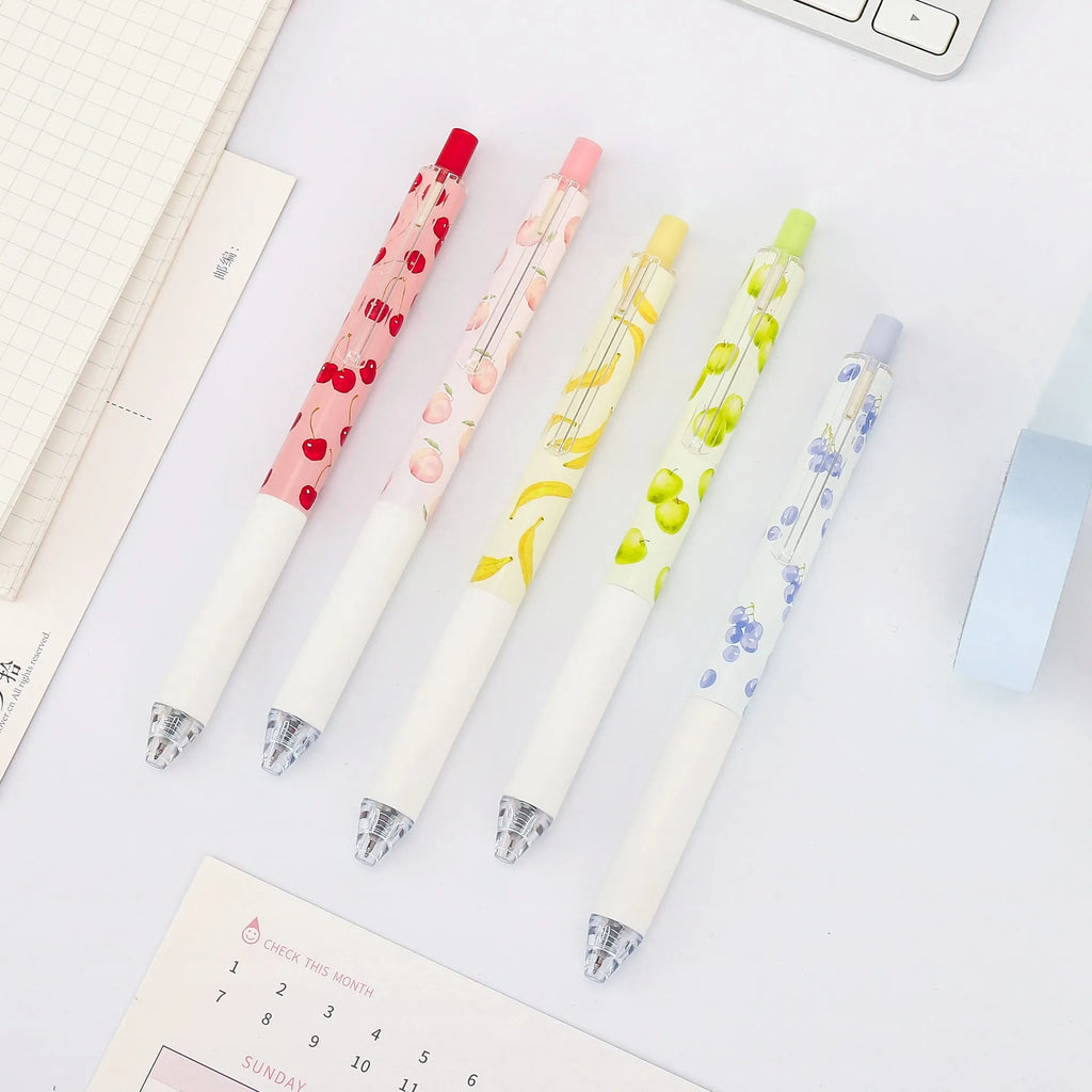 Three fruit-themed scented pressurised pens with 0.5mm black ink refills on writing surface