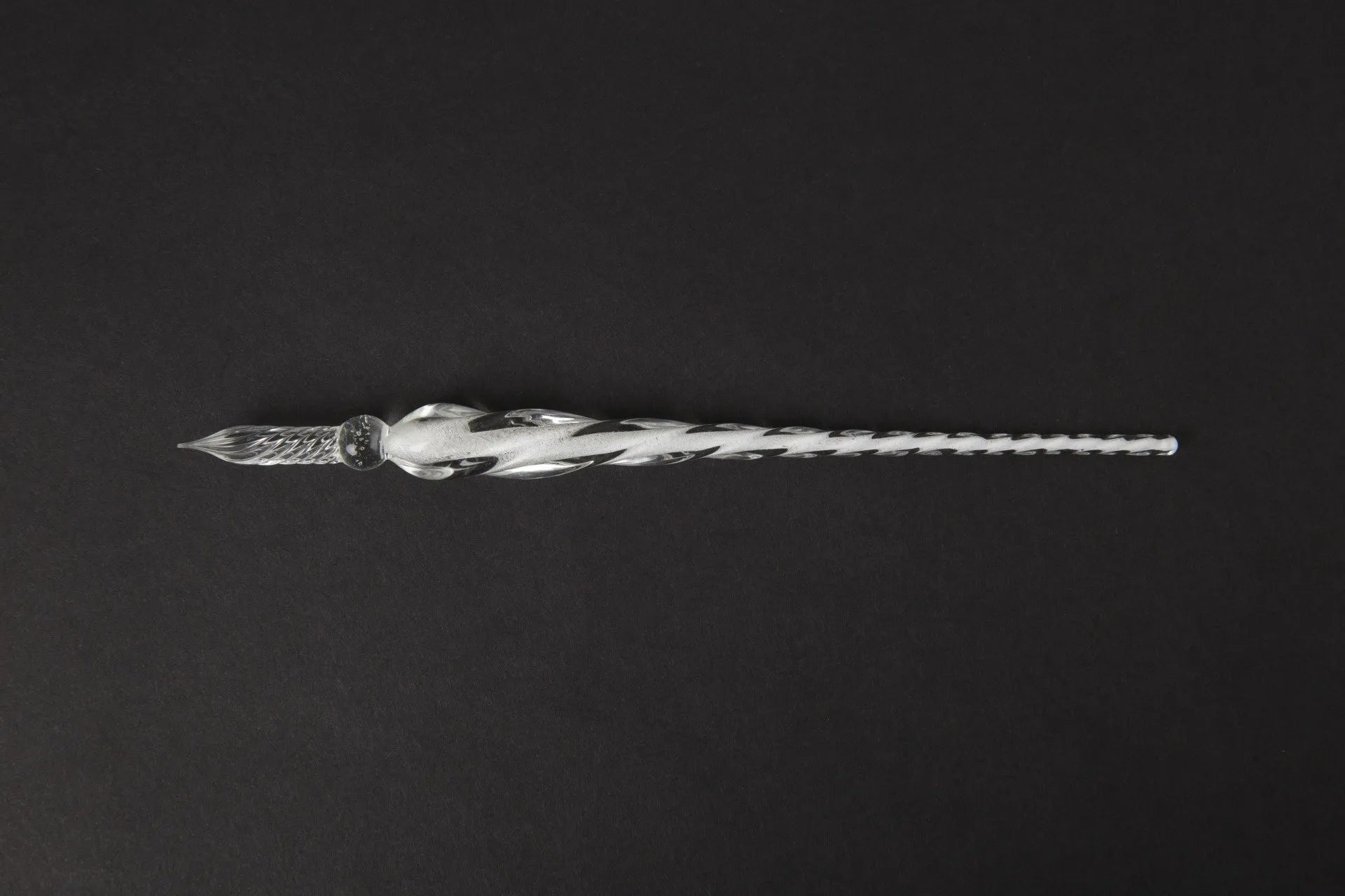 Transparent glass crystal pen with coloured ink visible inside, abstract modelling design