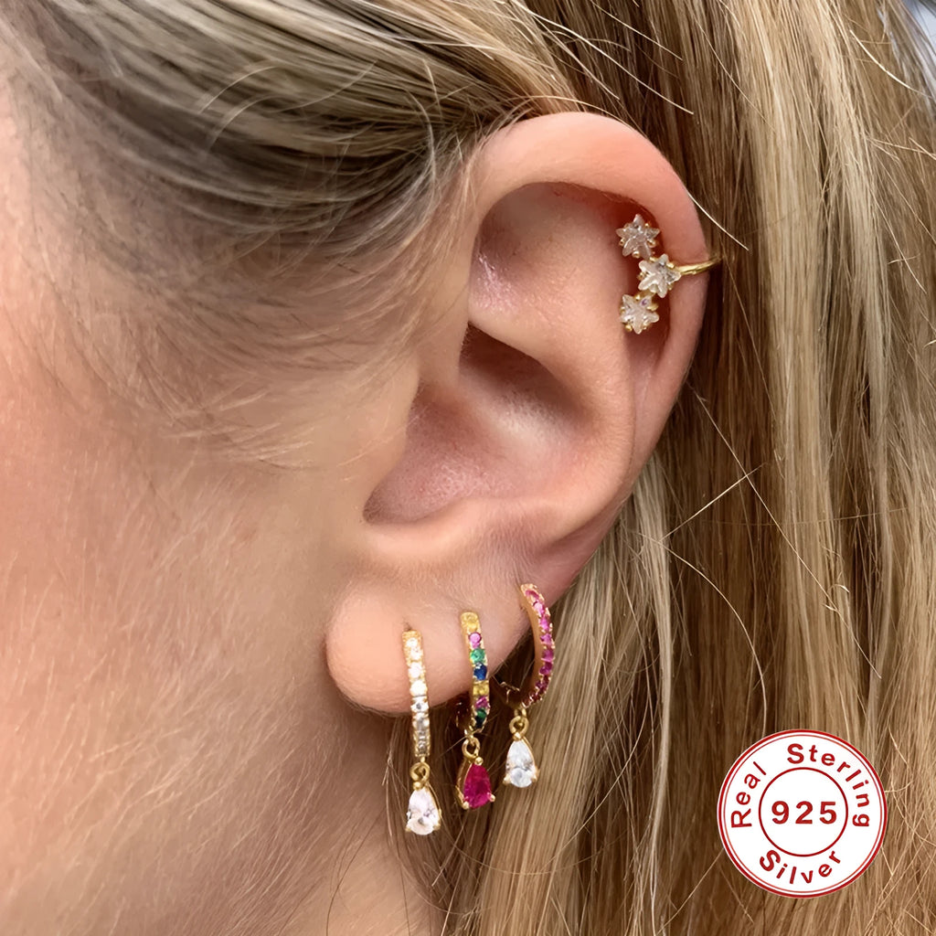 Geometric water drop sterling silver earrings with electroplated finish and sparkling stone detail.