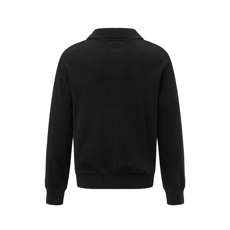 Man wearing a loose fit black pullover sweater for casual leisure wear.