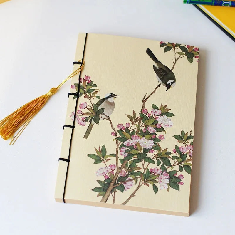 A5 antique wire-bound notebook with retro painting cover, thread binding, and black tassels.